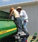 photo showing research team vacuuming the drill planter clean between plantings of different soybean cultivars