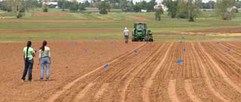 photo of two team members watching the planter in acton