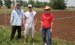 photo of research team field crew assembled together while taking a break from irrigation system installation