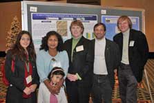 Photo of research team in front of Elena Prior's conference poster.