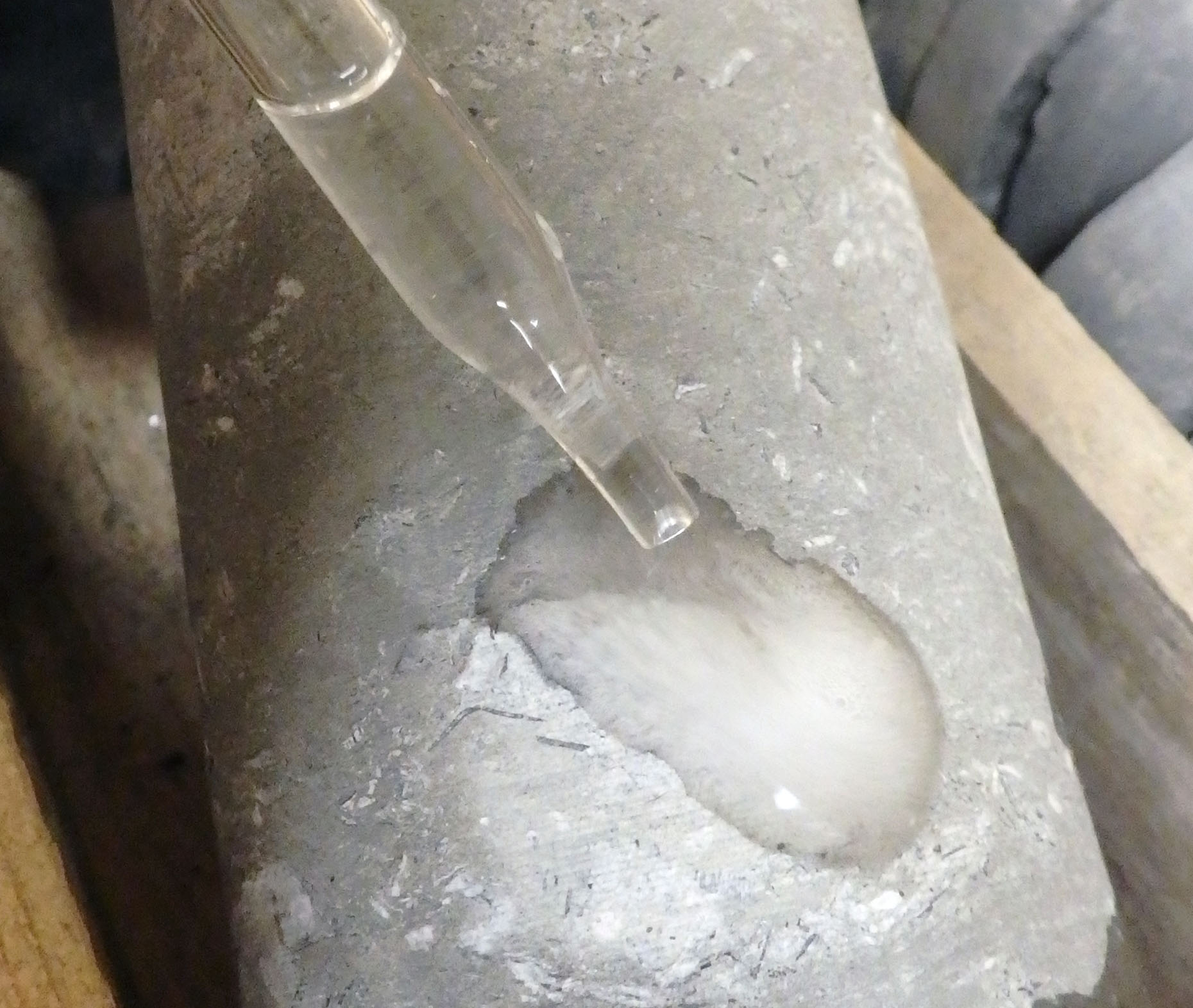 Testing core with dilute hydrochloric acid. If all parts of the rock fizz a lot, the rock is limestone.