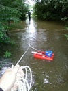 Using a StreamPro© acoustic Doppler sonar current profiler to measure creek discharge during a high-flow event at Cane Run Creek, Kentucky Horse Park.