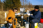 Glynn Beck and Kathy Takacs sample a monitoring well at the Sugar Creek CO2 enhanced oil recovery project site in Hopkins County.