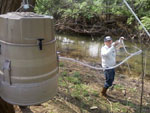 Jim Currens sets up an ISCO© automatic water sampler on Cane Run Creek at the Kentucky Horse Park.