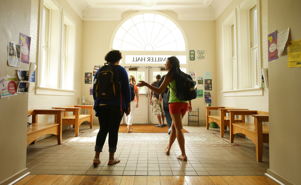 Photo of students talking as they walk the interior of UK's Miller Hall foyer