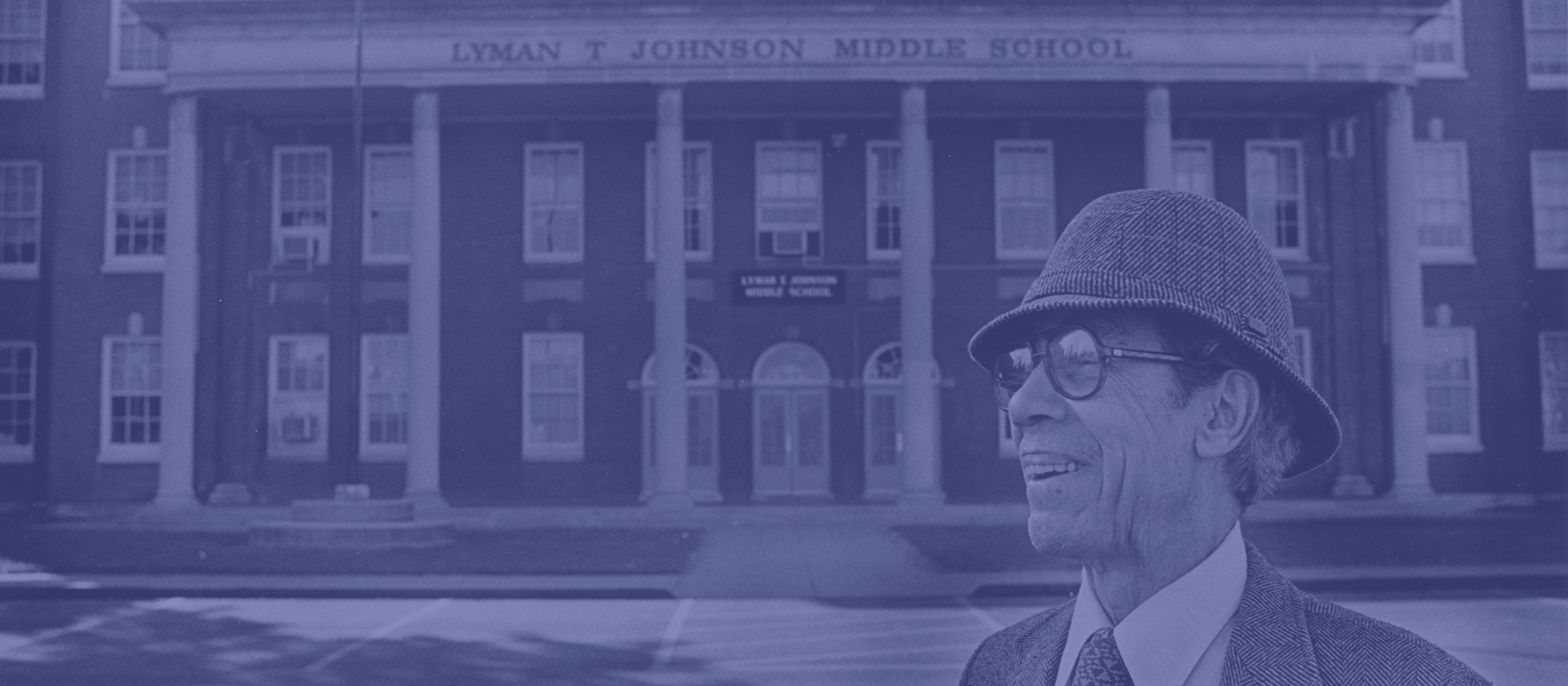 Lyman T. Johnson standing in front of school named after him.