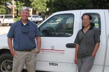 photo showing Bob Kemerait amd Weibo Dong standing beside a University of GA Truck