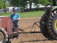 photo of Dr. Joe Amielan in field monitoring progress during seeding