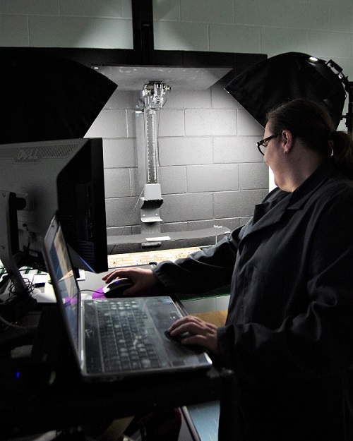 Natalie Fields takes photos of cores stored at the facility for posting online. Natalie Fields takes photos of cores stored at the facility for posting online.