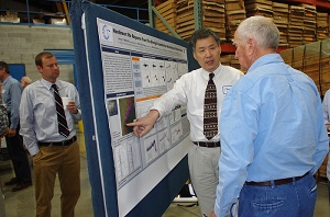 Geologic Hazards Section Head Zhenming Wang talked about his poster during a break in the morning talks.