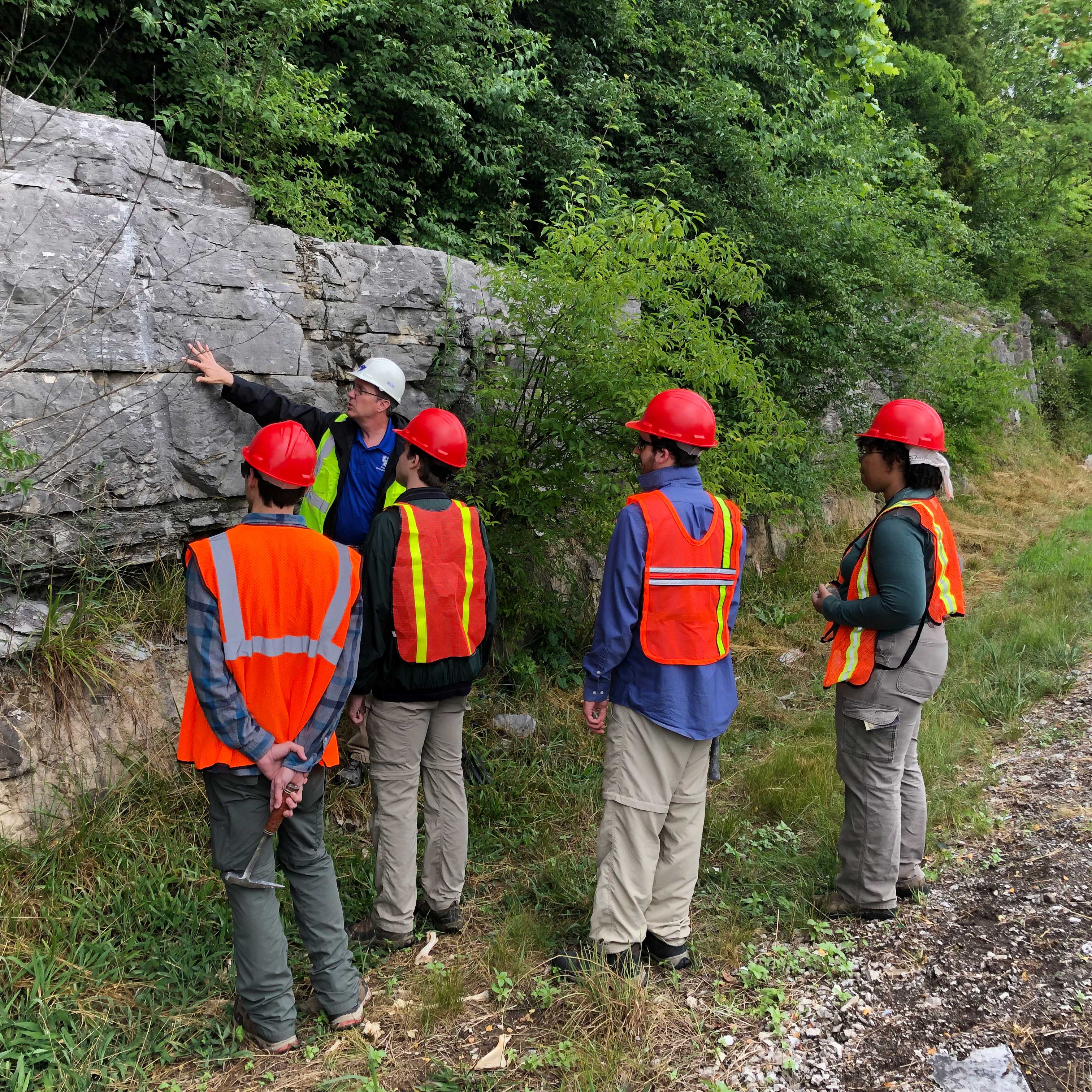 Dr. William Andrews with Potter interns at an outcrop
