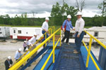 Donald Strehle of Sandia Technologies leads another group onto the drill platform.