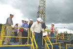 Donald Strehle leads a tour group off the walkways over the mud tanks.