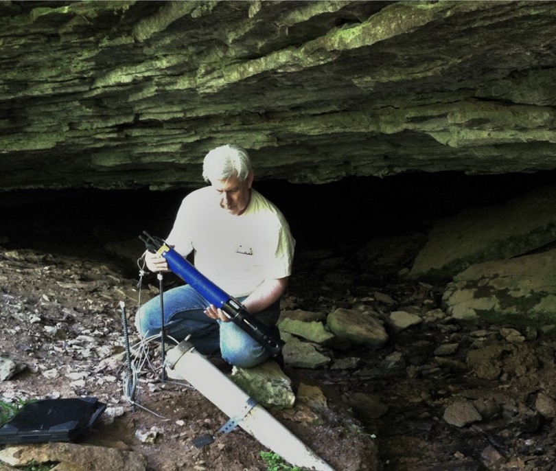 Chuck Taylor installing water-quality monitoring equipment used for an investigation of a cave spring near Campbellsville, KY