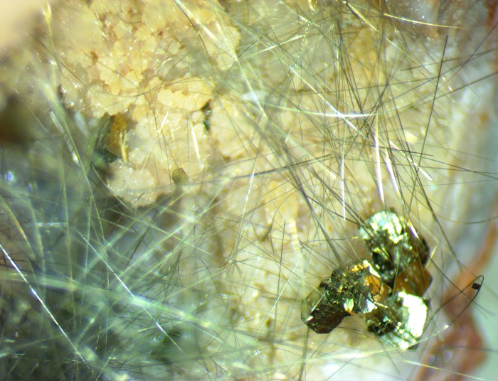 A pyrite cube attached to a millerite ring.