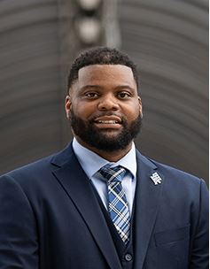 Corey A. Moore smiling warmly.