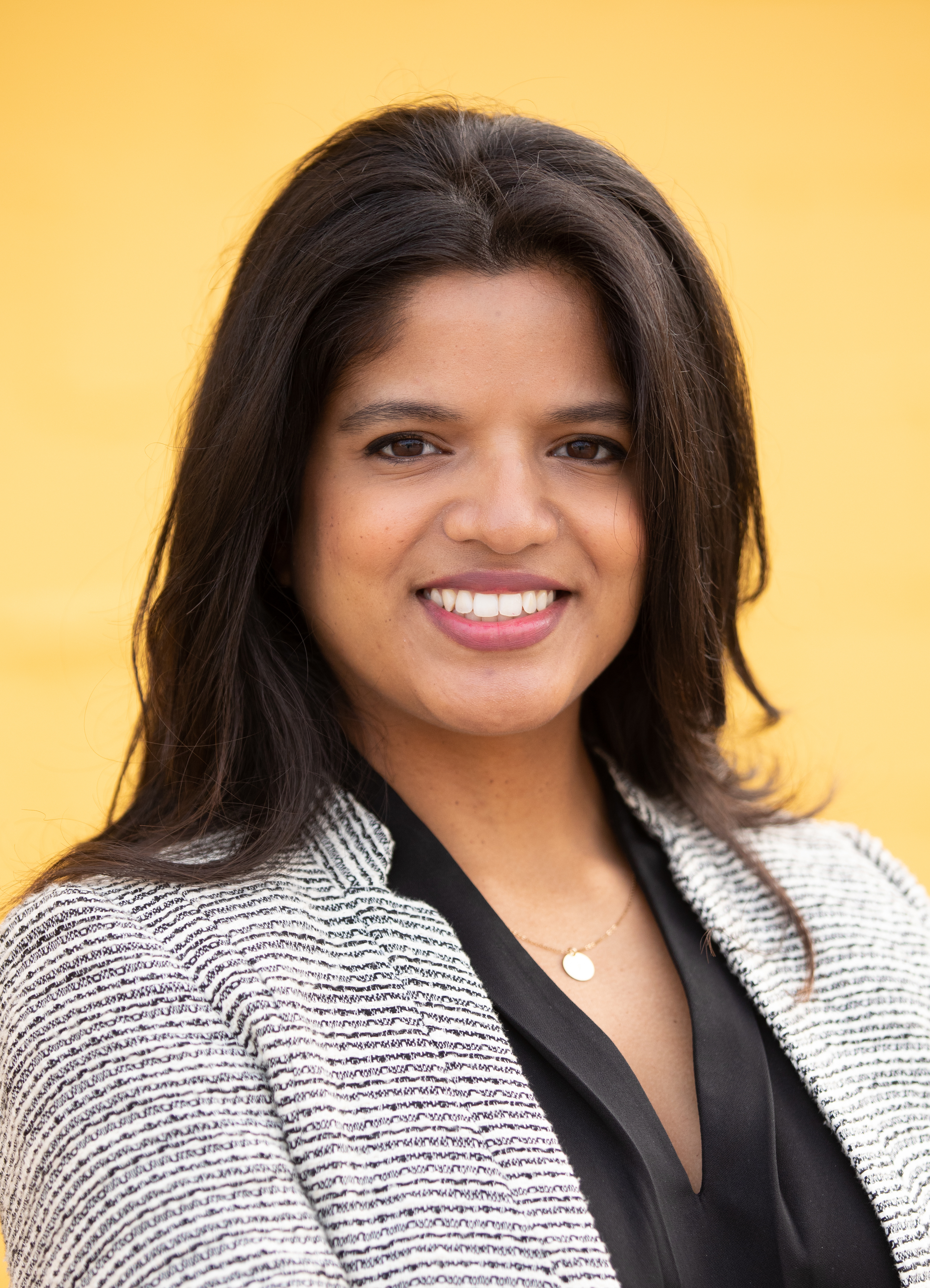 A headshot photo of a woman smiling. 