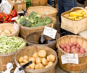Baskets of vegetables for sale at a farmers market