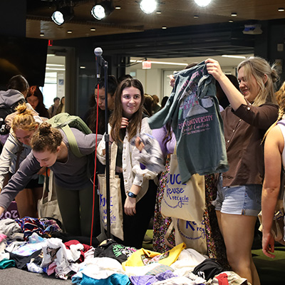 University of Kentucky students browsing through clothes at the Pop Up Thrift Shop.