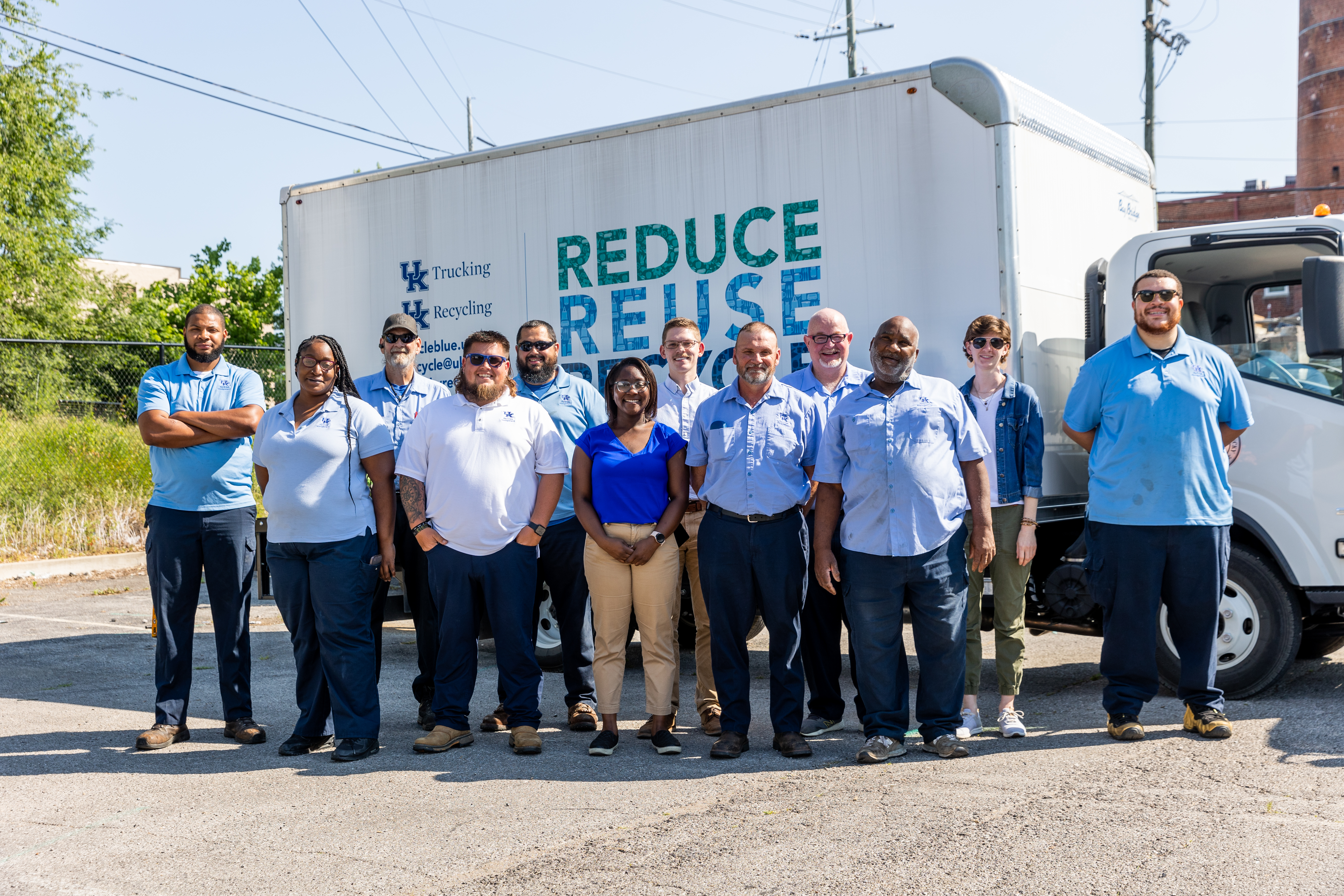 Group staff photo of UK Waste Management, Trucking, and Recycling. In the back row is Louis, Ken, Anthony, Ryan, Michael, Katie, and Jordan. In the front row is K'rissa, Shaun, Breanna, Tim, and Raglan