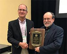 Dr. Robert Geneve, right, receives the Porter Henegar Memorial Award