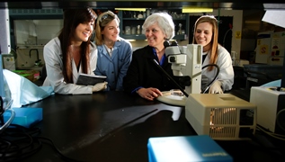 Vice President Lisa Cassis with several women students