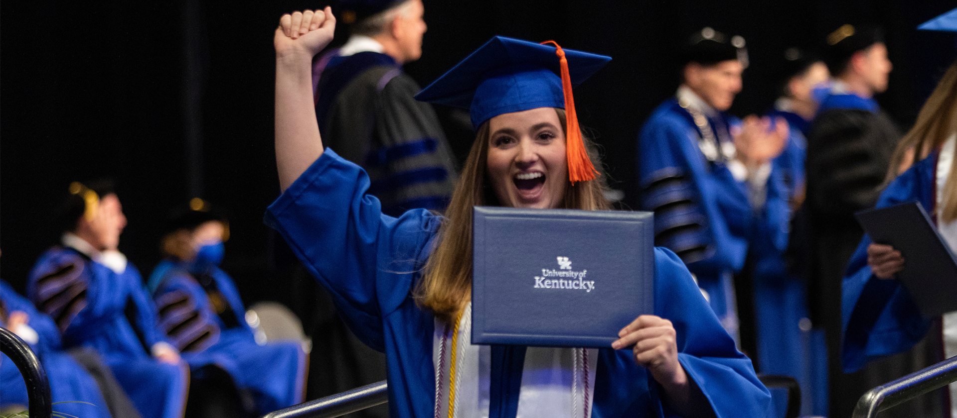 Female Student Holding Diploma Celebrating