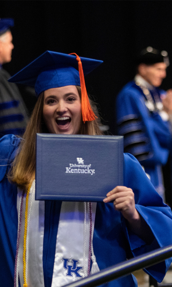 Female Student Holding Diploma Celebrating