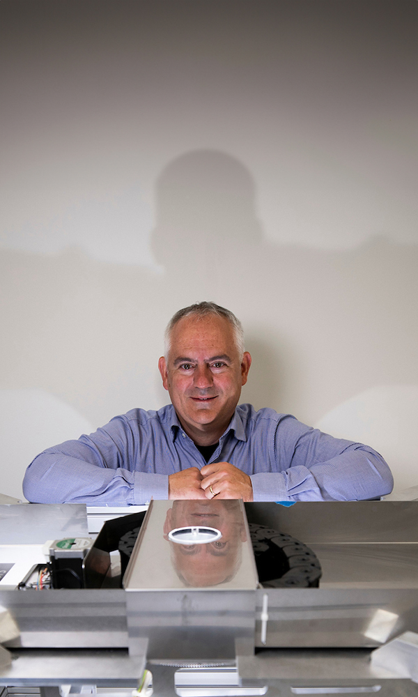 UK Professor Brent Seals standing above the scrolls.