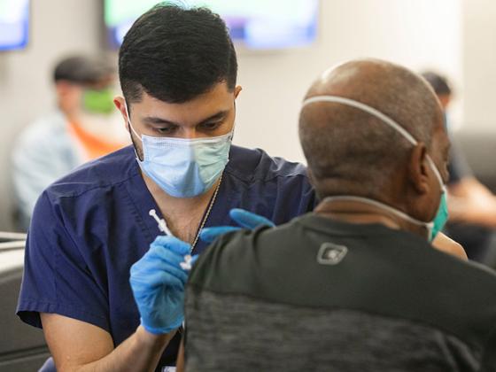 A Person Receiving a Covid-19 Vaccination