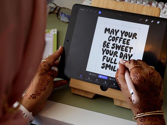 Picture of Siddiqi’s hands designing on her iPad.