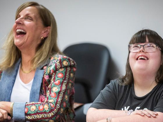 Teacher and student laughing